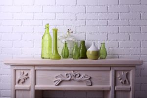 fireplace mantel with glass bottles