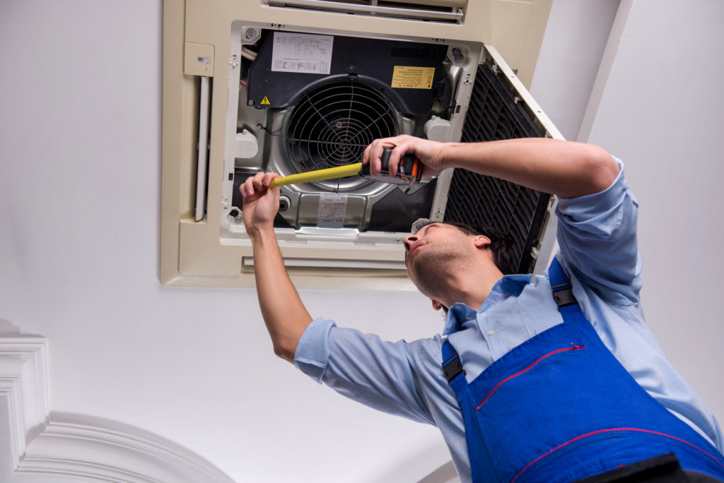 HVAC contractor repairing an HVAC unit in Rockville